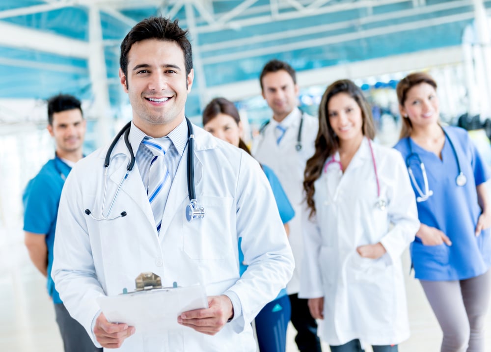 Male doctor with a medical group at the hospital Male doctor with a medical group at the hospital